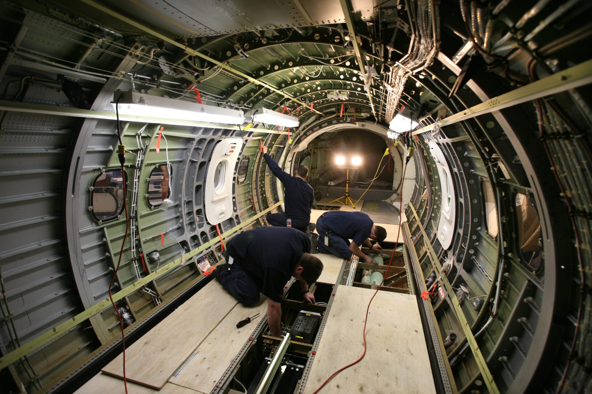 Photograph of Dash 8 maintenance and AMEs in a Hangar