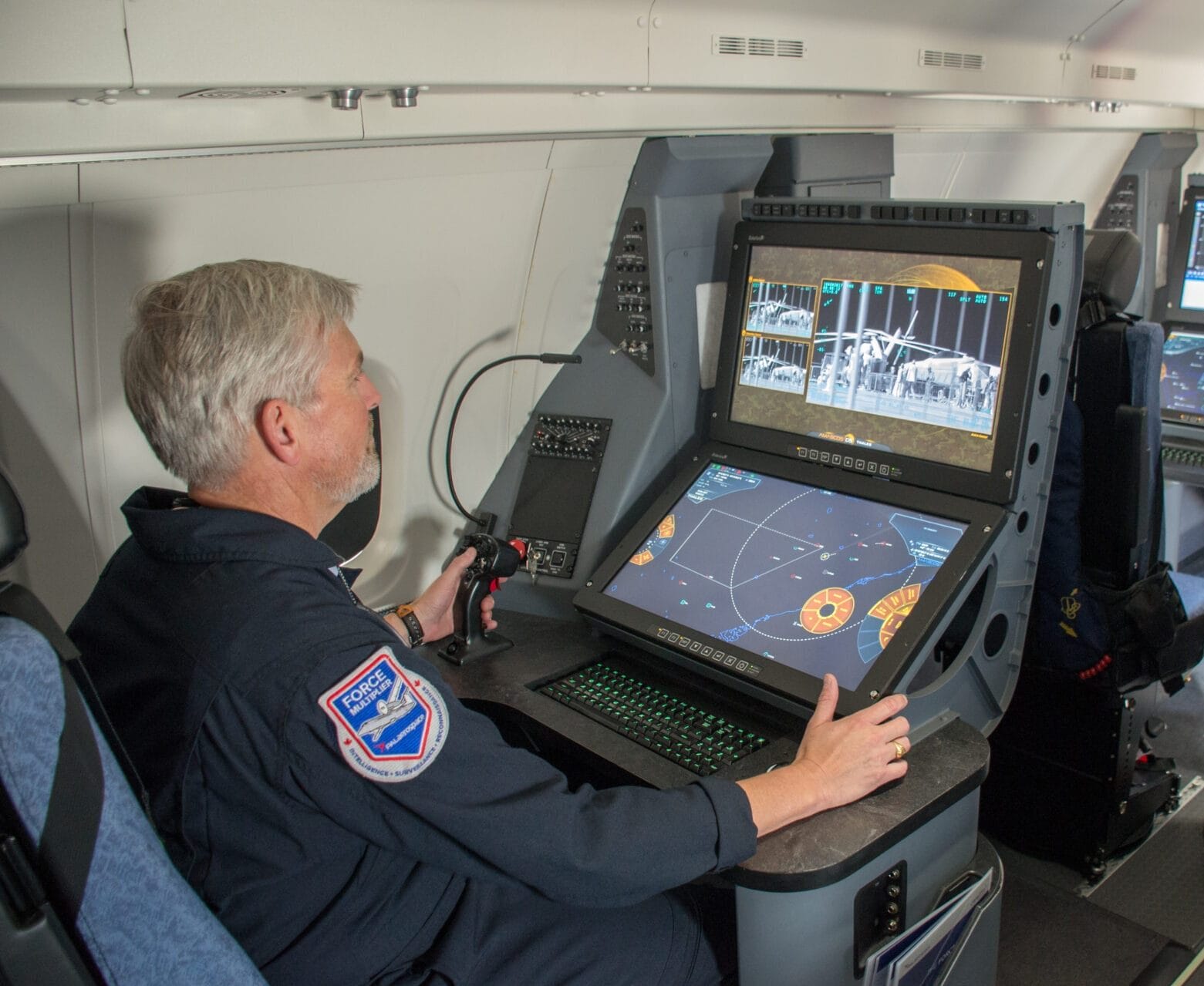Photograph of operator and console for Force Multiplier Program by PAL Aerospace