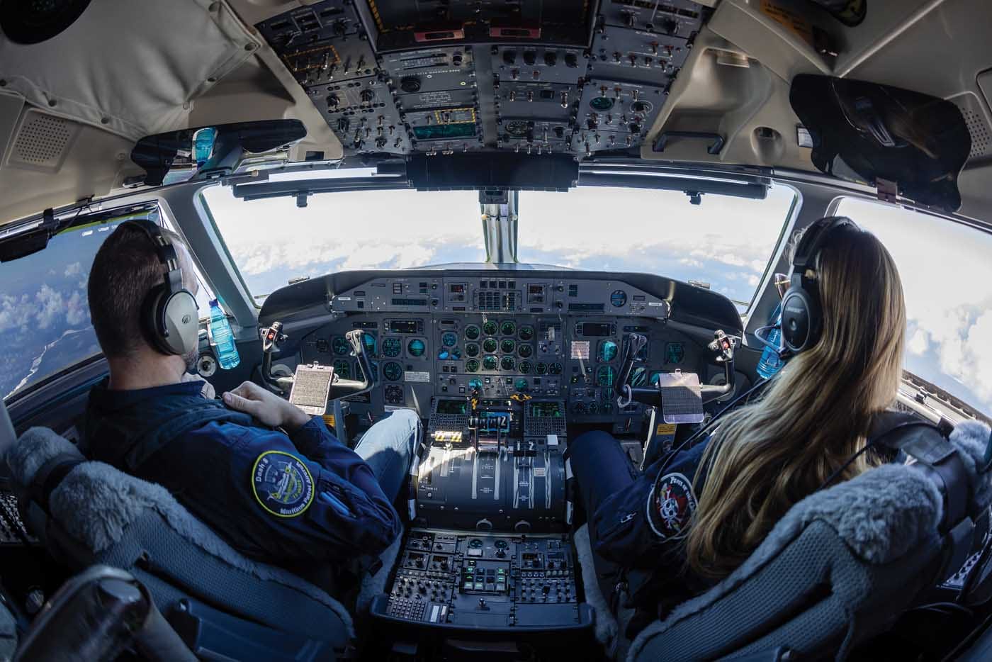 Photo of male captain and female first officer in the cockpit of a Dash 8-100 MSA aircraft.